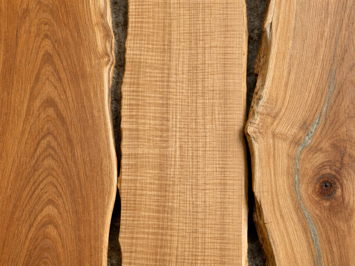 Three natural-wood boards showing different grain figure side by side